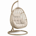 Poltrona sospesa in rattan e acciaio con cuscino crema